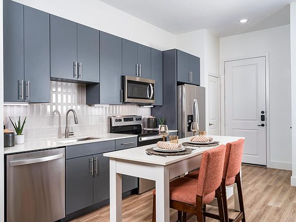 Discover ample space for meal prep and entertaining with the expansive chef''s kitchen island at Modera Garden Oaks.