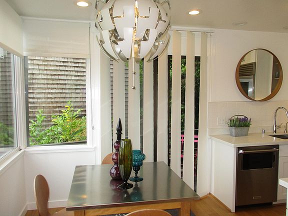 Dining area with views of water and sliding door to a private outdoor deck
