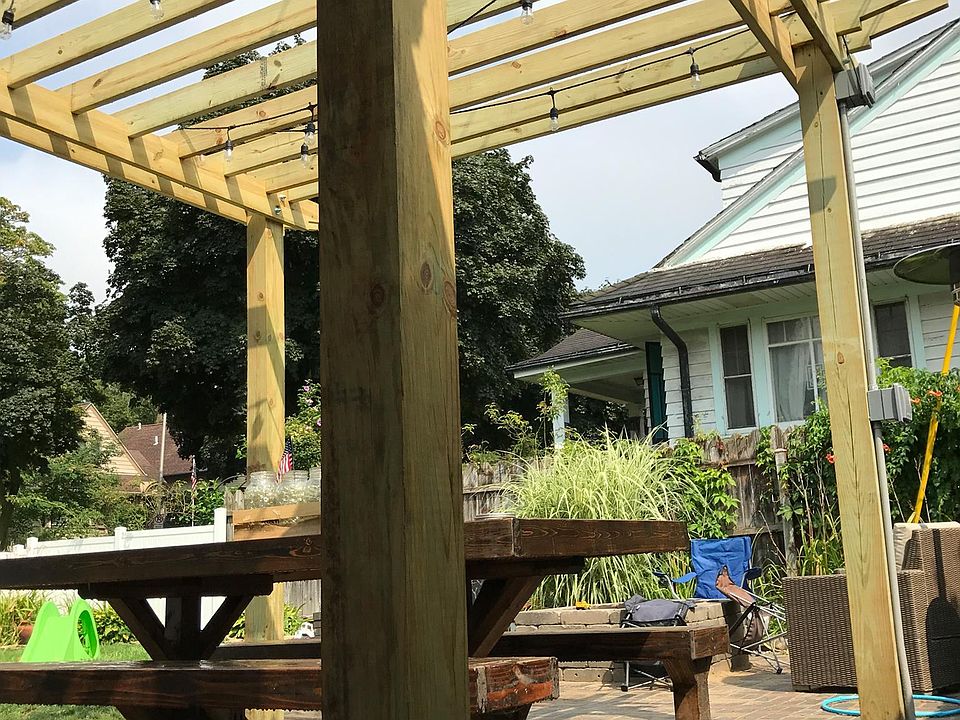 Shared back patio with pergola and string lights.