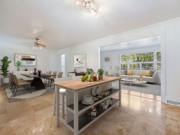 Kitchen and dining area feature a tile floor. The kitchen has a new range and dishwasher.