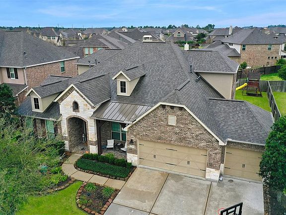 This beautifully landscaped property features a 3 car garage, stone and brick elevation, and covered porch.