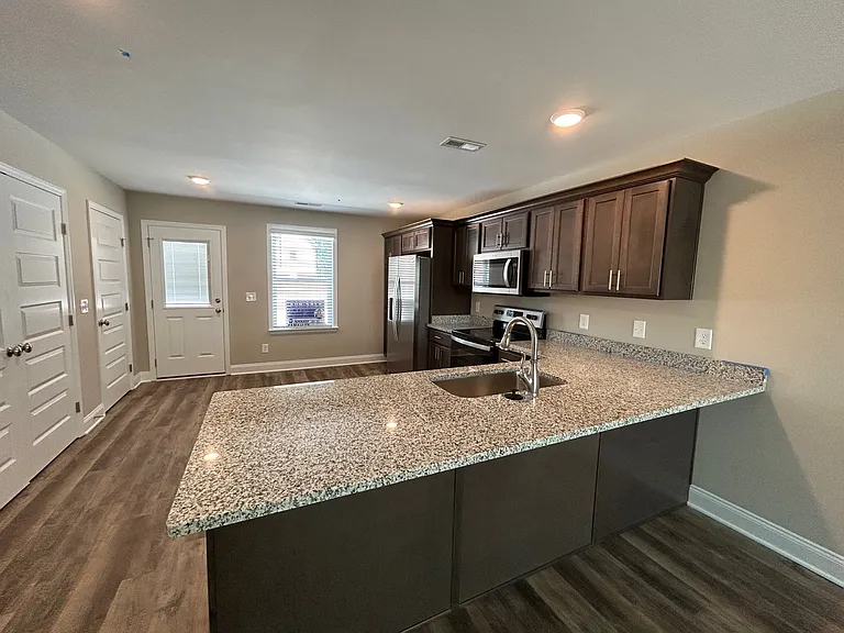 Spacious Kitchen with bar stool area and Laundry room is across from Kitchen