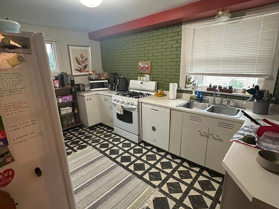 kitchen with dishwasher, fridge, microwave, gas stove.