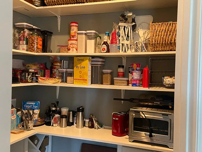 Custom built shelves and cabinets in pantry for optimal storage