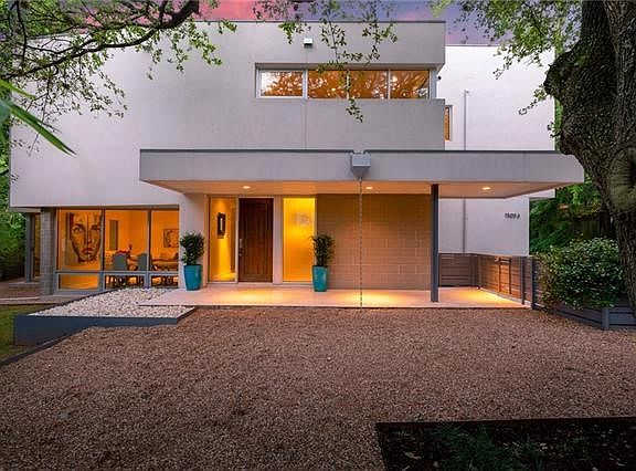 Welcoming front entrance with covered limestone porch.