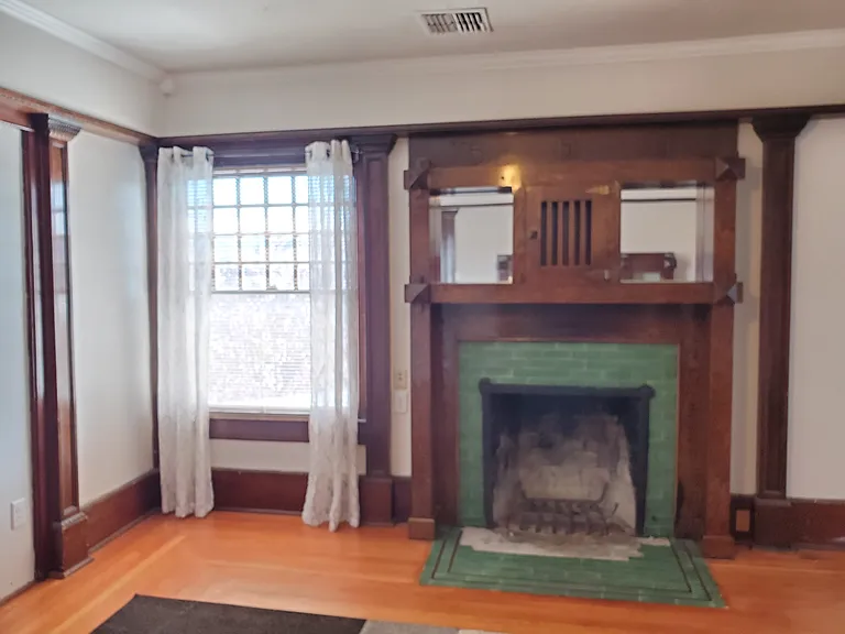 Living Room Original 1905 Fireplace. We have replaced the missing tiles since this photo was taken. The fireplace is just for looks, not functioning. Chimney was capped off many years ago.
