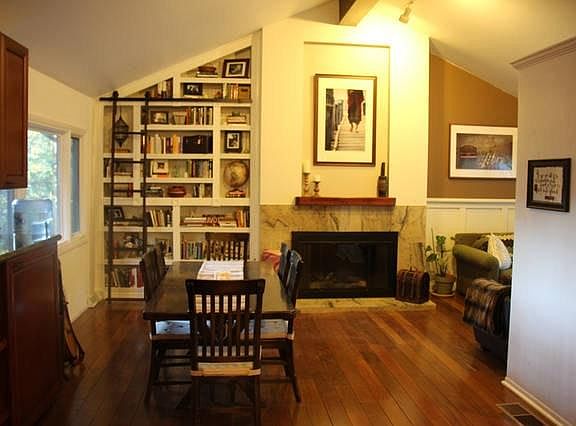 A view of the dining room, fireplace and reading nook. The h