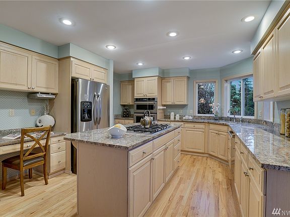 Remodeled kitchen boasts slab granite counters, gas cook-top, full suite of Stainless Steel appliances and refinished hardwood floors.