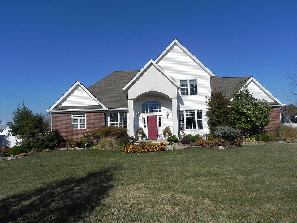 Professional landscaping and large backyard with vinyl fence