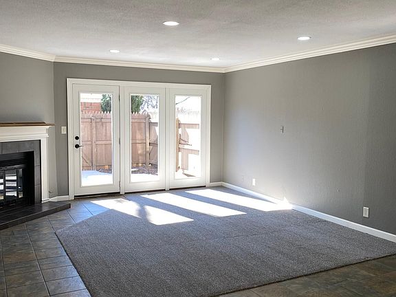 Living with patio doors to private patio, new carpet, lighting, crown modling