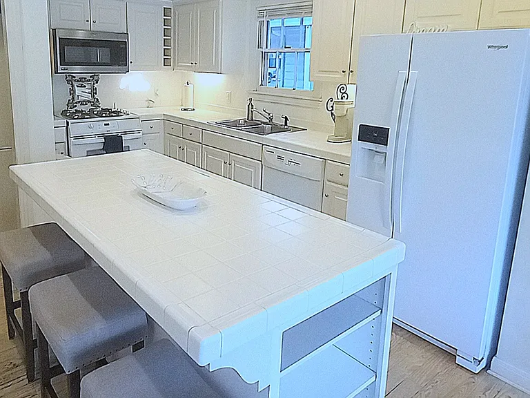 Fully equipped kitchen features fridge with ice and water through the door, gas cooking, electric oven, microwave