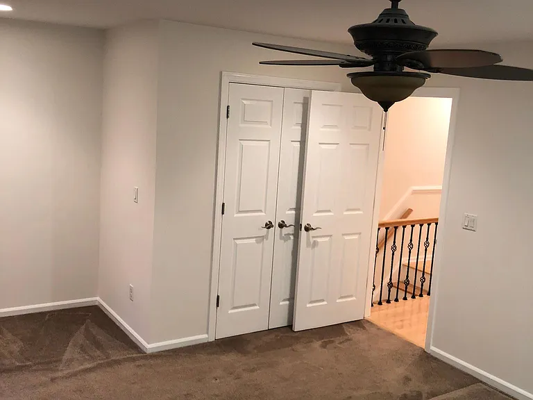 Comfortable bedroom with recessed lighting and closet space.