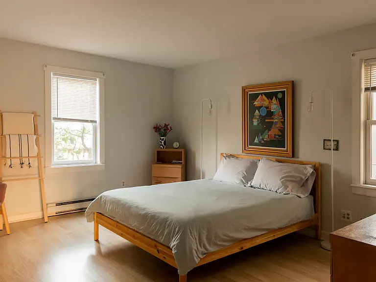 The bedroom features a queen bed and lots of closet space