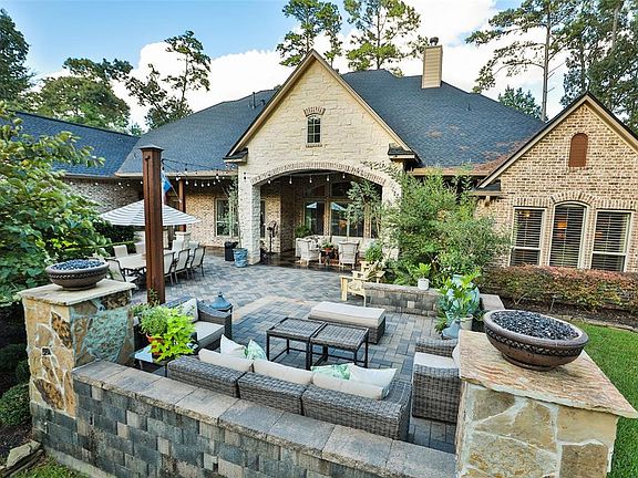 Rear elevation of the house looking over the raised seating area with dual gas fire bowls
