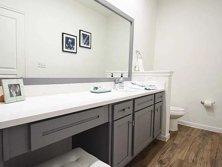 Soaking tubs, framed mirrors and double vanities make up the modern baths