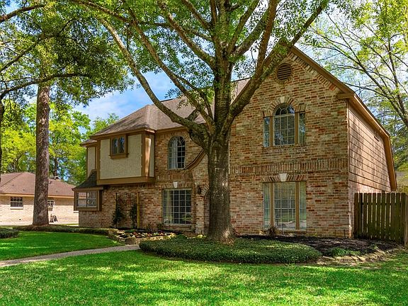 This stately entrance with large mature trees is grand.