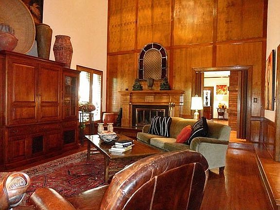 Library paneled den with fireplace