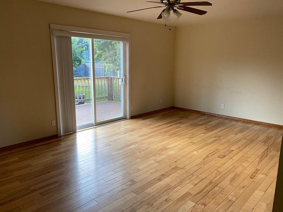 Living with wood floors and Slider out to Deck and Fenced Backyard