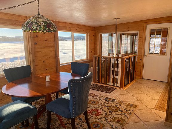 Sun room with fire pole to basement. Door leads to large open air sunroom/mud room.