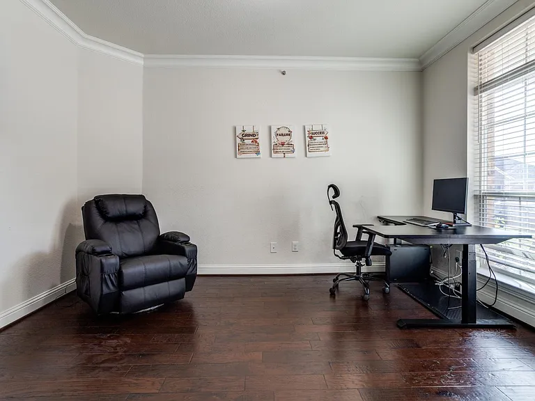 Home office featuring dark hardwood / wood-style flooring and crown molding