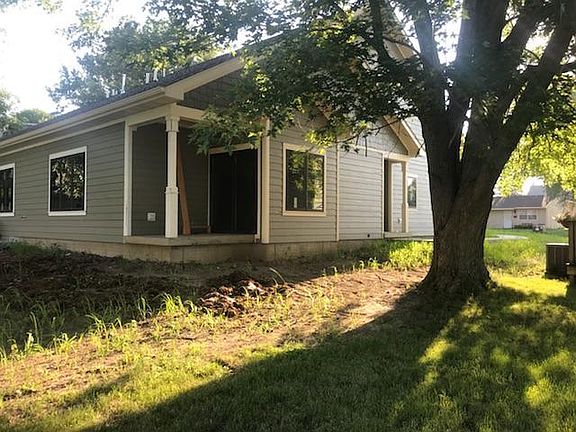 Rear view. Sliding door exits to porch. Railing and small