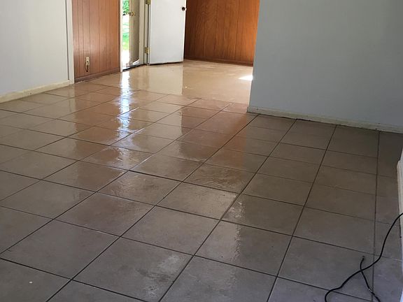 LIVING ENTRY THROUGH TO DINING AND ENTRANCE TO GARAGE AND LAUNDRY CONNECTIONS