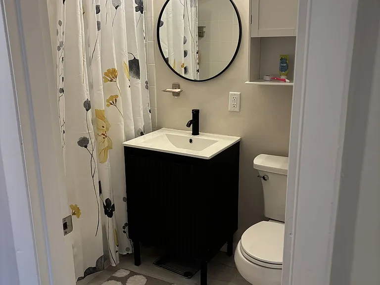 Updated bathroom with shower over tub.