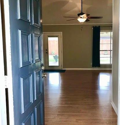 Entering the home there is a coat closet to the left and the flooring is laminate in the living area, kitchen and bedrooms. The french doors and large windows offer great lighting and a nice view of the large backyard.