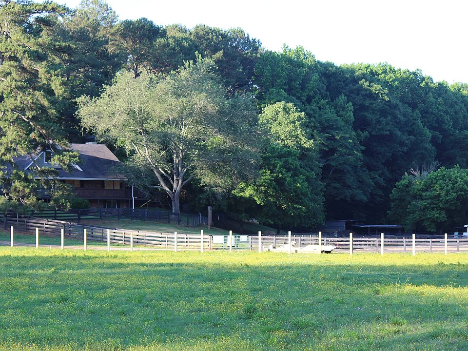 Lovely furnished farm home for rent on over 7 acres in Milton, GA. Set back & very private.