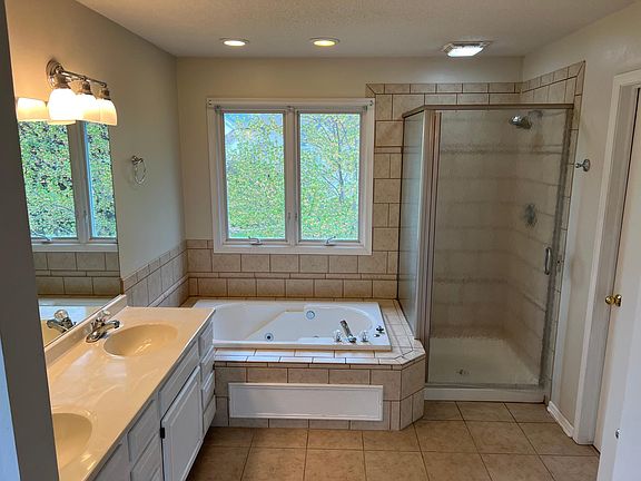 Master bathroom with standup shower and a jacuzzi