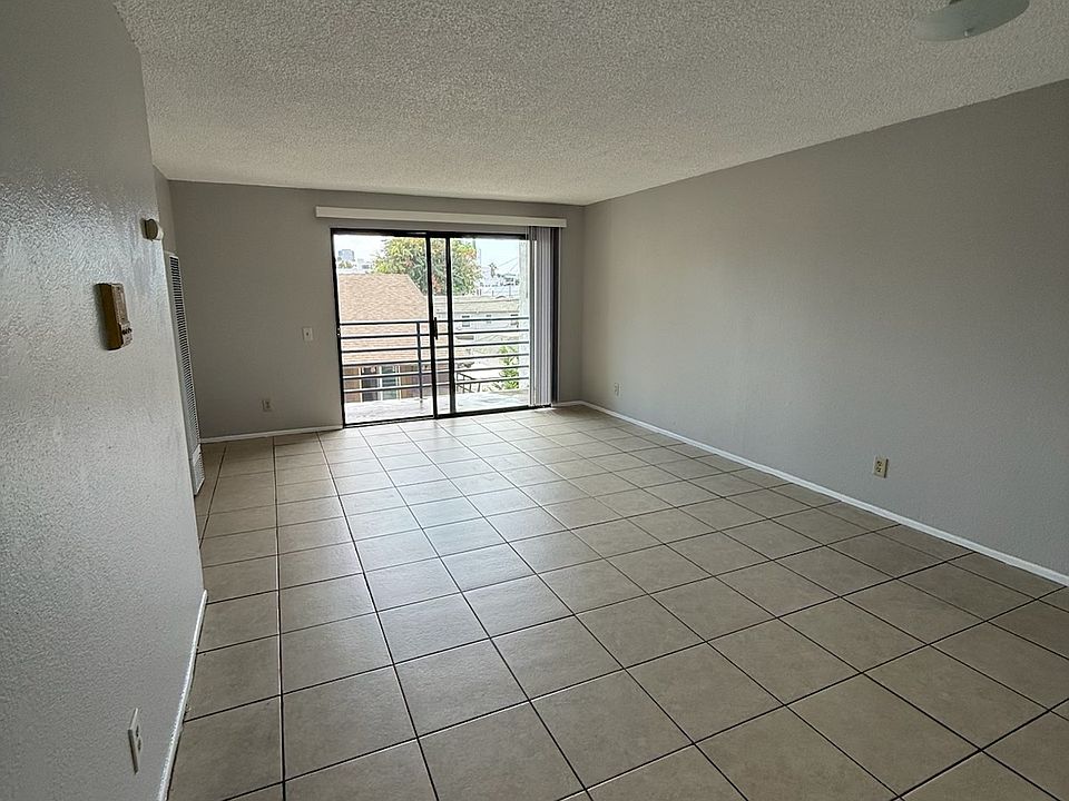 Spacious and well lit living room with private balcony