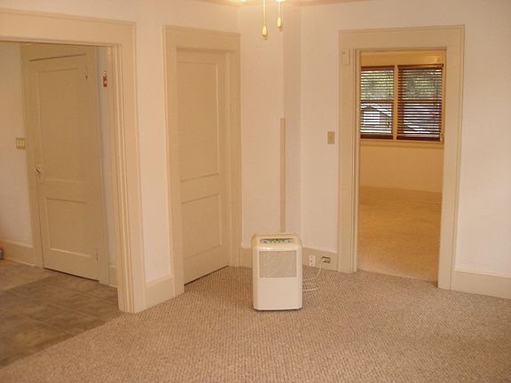 Shot from living room with kitchen arch on left and bedroom