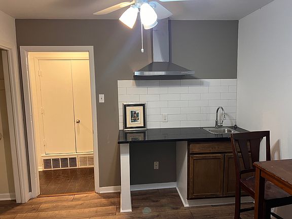 Kitchenette, includes hotplate, refrigerator and vent hood.