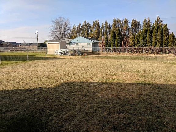 Large fully fenced yard with garden area at the back by the grapes