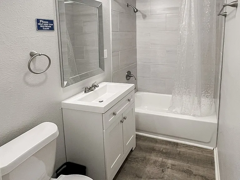Shared bathroom with tub and shower