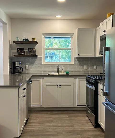 All stainless steel appliances and a 5-burner gas stove.