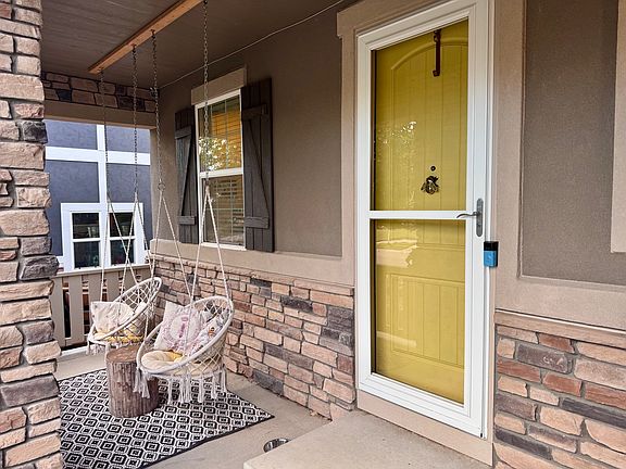 Front door with front porch swings