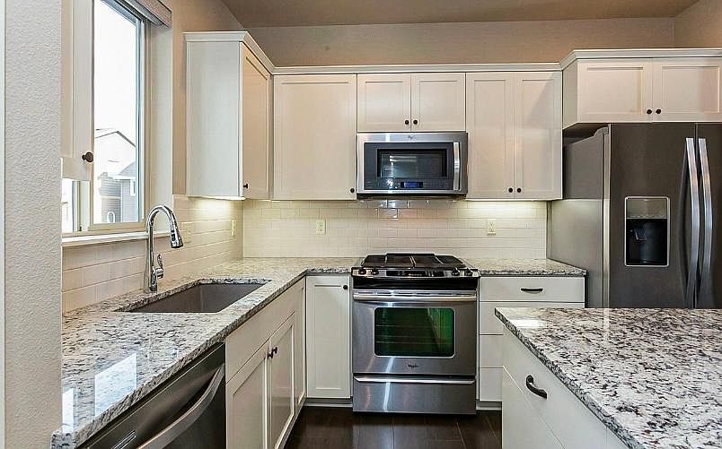 Gas stove great for cooking with plenty of storage space.