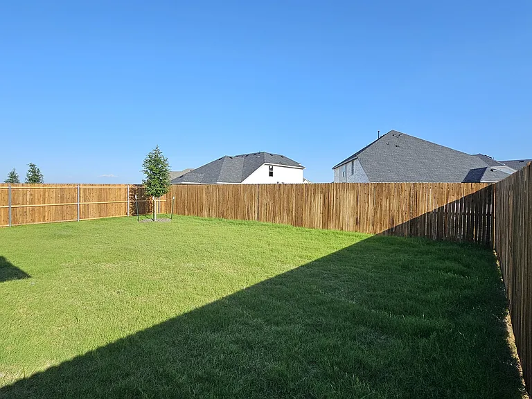 A large, private backyard with plenty of room for outdoor activities.
