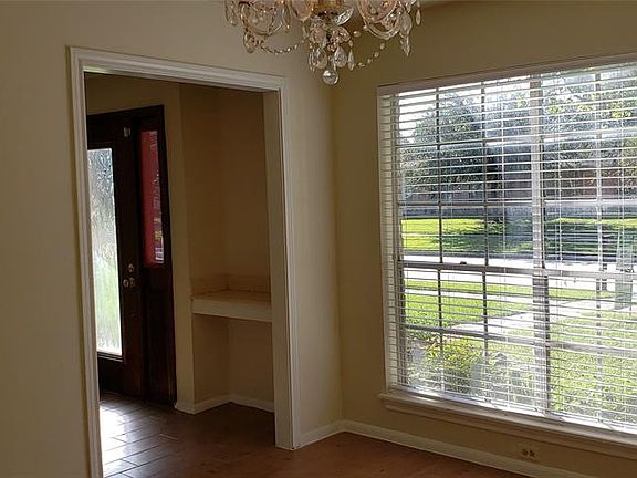 Elegant Formal Dining Room with Wood-Look Tile Flooring.