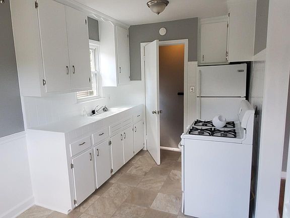 Kitchen with stove, refrigerator and a dining area