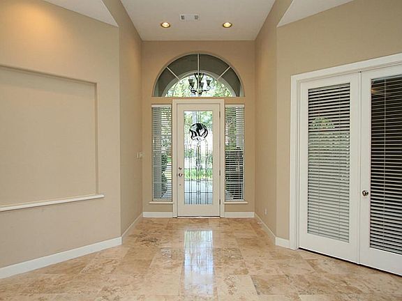 The bright foyer with transoms and art niche greets your guests and lead them into the home.