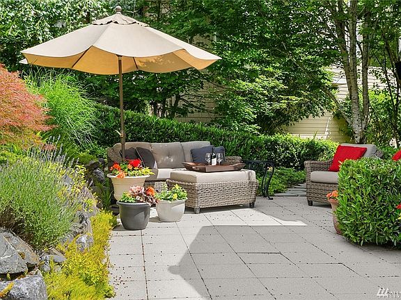 One of several serene spots to relax and enjoy the grounds. This outdoor sitting area is located in the front of the home and offers wonderful privacy. 