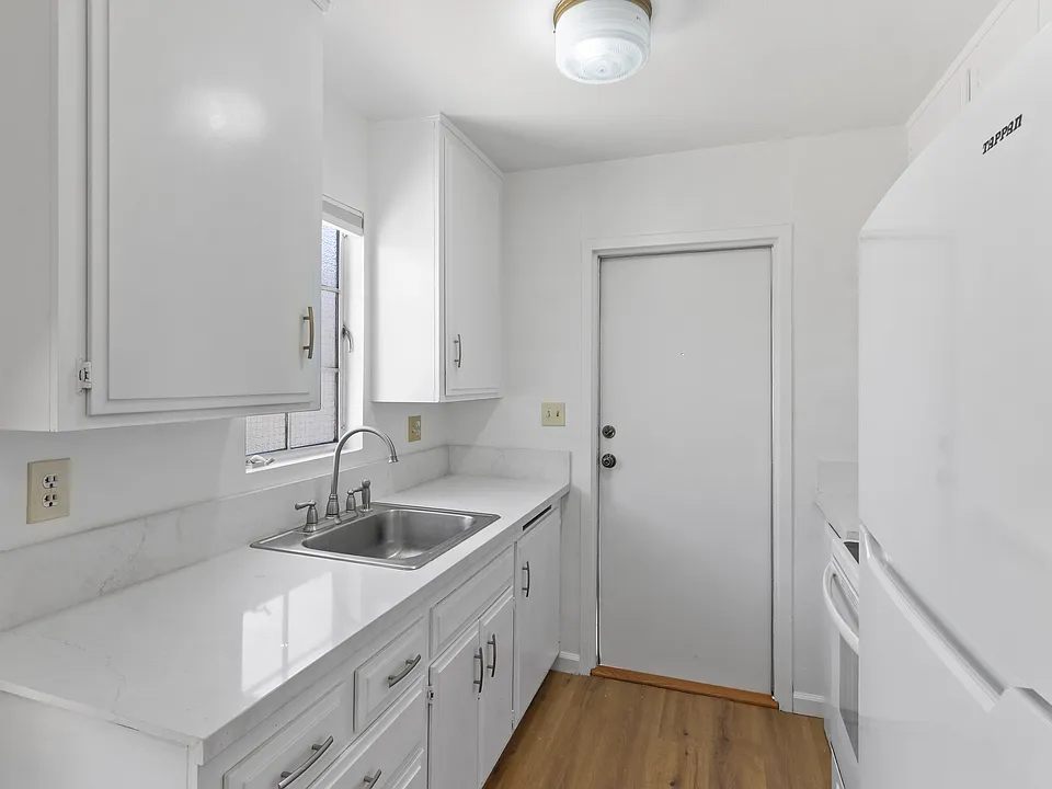 Kitchen view and looking into front door access