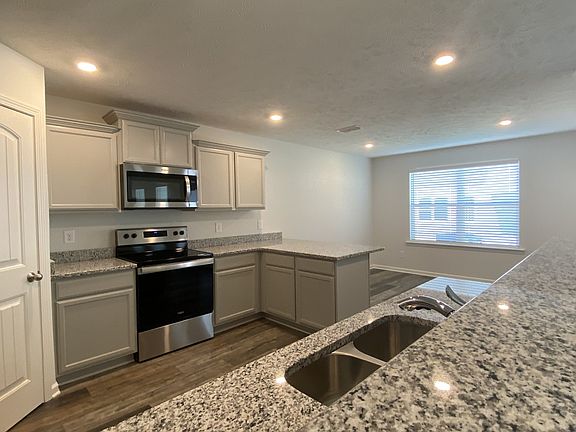 Granite kitchen with stainless steel appliances and refrigerator, walk in pantry, upgraded painted