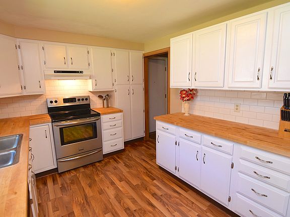 Freshly remodeled kitchen with white cabinets, new counter tops and flooring.  You will love the amount of counter top space in this kitchen
