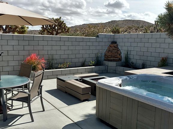 Hot tub, fire pit, patio furniture and waterfall