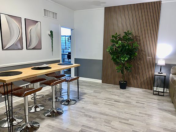 Enjoy meals at the modern dining set with comfortable seating for six_perfect for family dinners or casual gatherings.