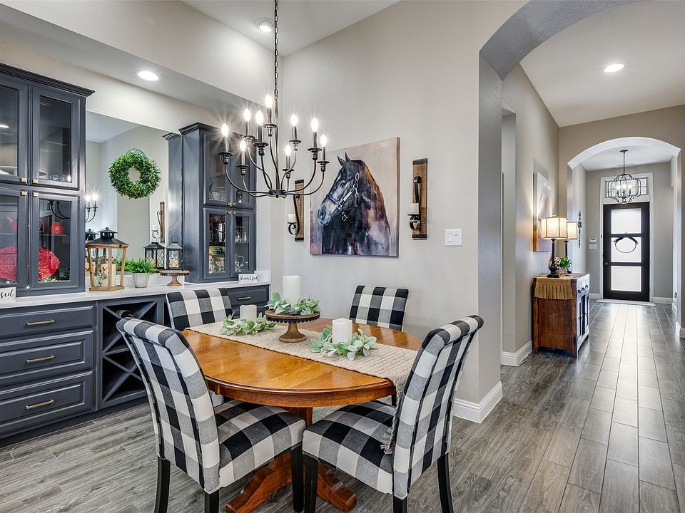 Gorgeous built-in hutch in dining area with updated lighting.  Extended wood-look flooring for easy care living.