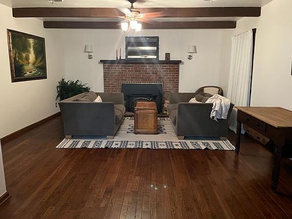 living room with wood burning fireplace